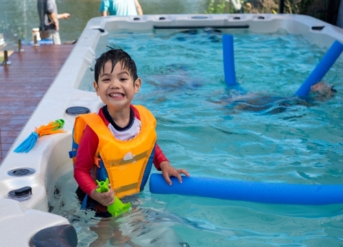 a kid having a great time in the pool - Australian Stock Image