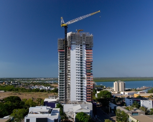 A large apartment block in the process of being built near a harbor - Australian Stock Image