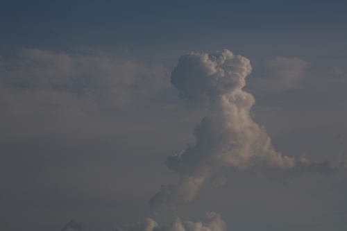 A large, towering cloud formation against a blue sky. - Australian Stock Image