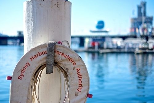 a lifebuoy hanging on one of the pillars at Darling Harbour - Australian Stock Image