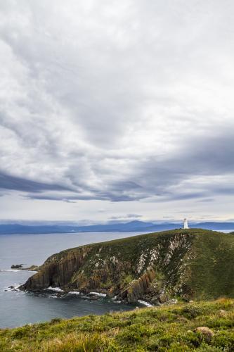 A lighthouse on a peninsula. - Australian Stock Image