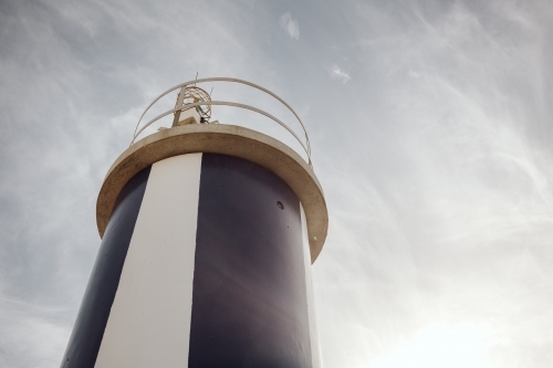 A lighthouse with a cylindrical shape under the clear sky. - Australian Stock Image