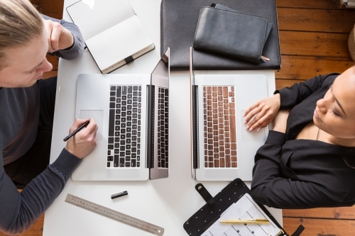 A male and female working opposite each other from above - Australian Stock Image