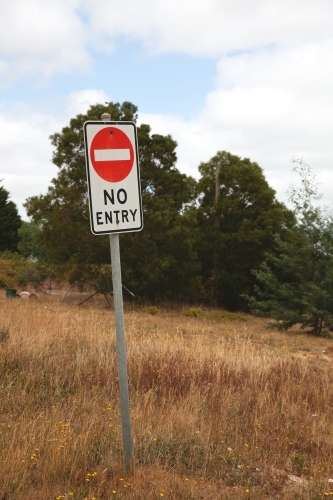 A "No Entry" sign in the middle of dry grassland - Australian Stock Image