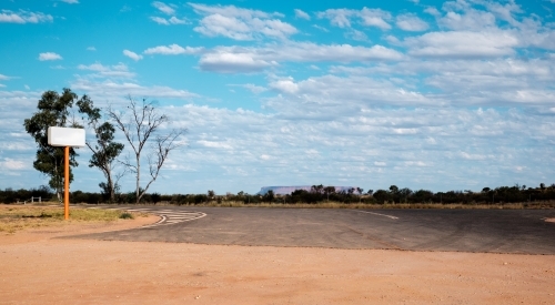 a petrol station sign at the outback with Mount Conner in the horizon - Australian Stock Image