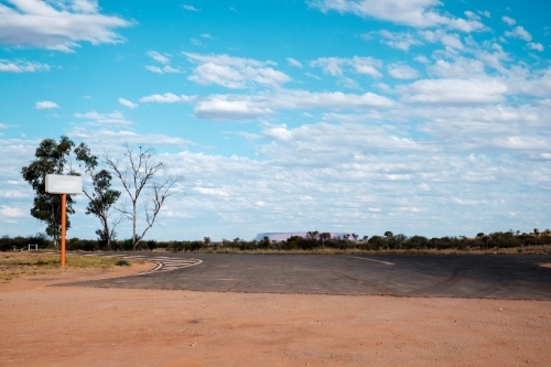 a petrol station sign at the outback with Mount Conner in the horizon - Australian Stock Image