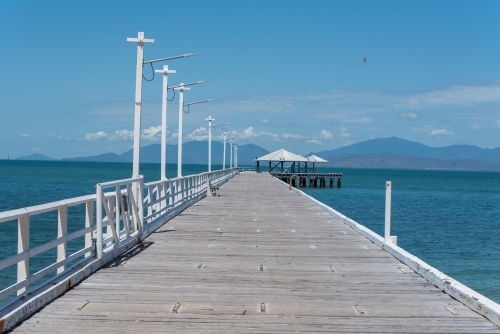 A pier with wooden floors, lamp posts, and railings - Australian Stock Image