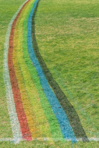 A rainbow arc painted on a grassy sports oval - Australian Stock Image