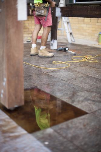 A reflection of a tradesman working on home renovations. - Australian Stock Image