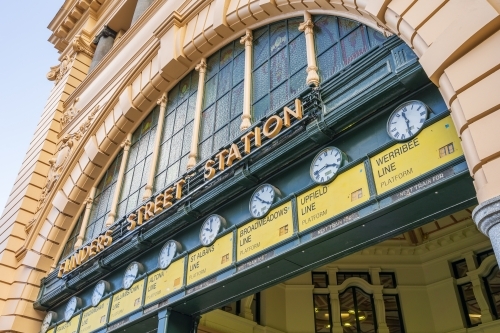 A row of old fashioned railway clocks at Flinders Street Station in Melbourne - Australian Stock Image