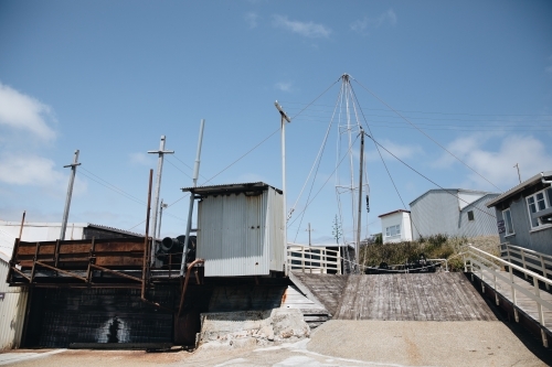 A slipway with small buildings on the side with hoist at the Old Whaling Station - Australian Stock Image