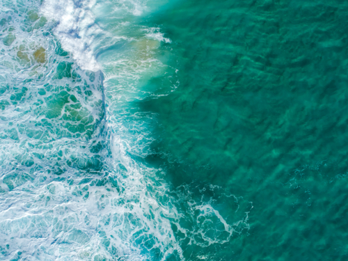 A small wave begins to crash on a shallow reef - Australian Stock Image