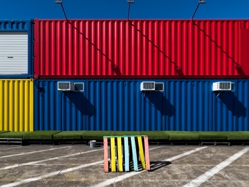 A stack of colourful shipping containers with air-conditioning units - Australian Stock Image