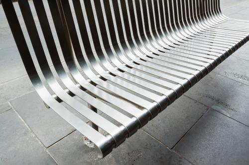 A steel bench on the footpath - Australian Stock Image