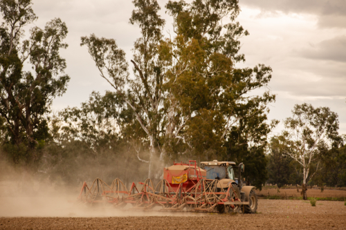 A tractor and seeder cowing crop in Central West NSW - Australian Stock Image