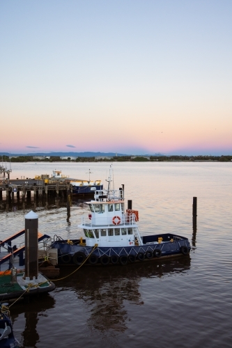 A tug boat on the Brisbane River at the Port of Brisbane - Australian Stock Image