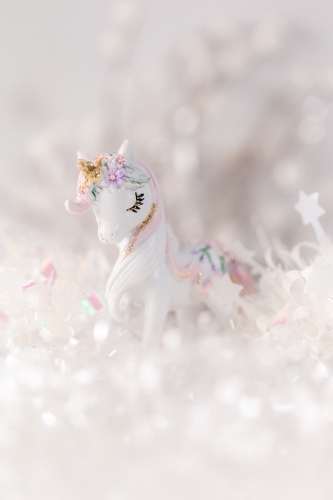 A unicorn figurine with a whimsical background. - Australian Stock Image