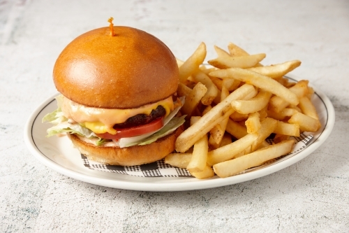 A vegetarian mushroom burger served with chips - Australian Stock Image