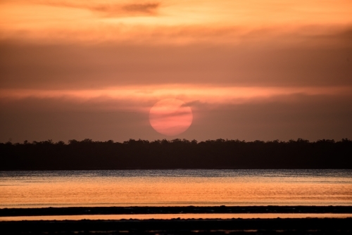 A warm sunset glow over the lake. - Australian Stock Image