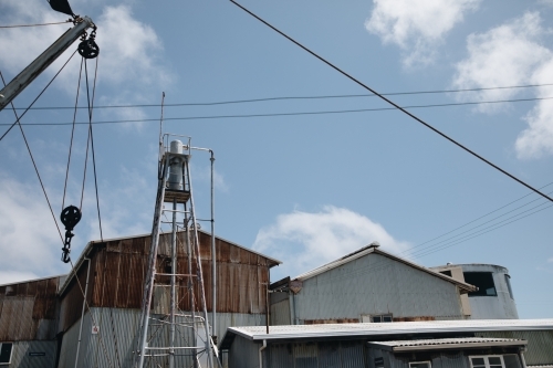 A water tower with old and rusted metal corrugated metal in Old Whaling Station - Australian Stock Image