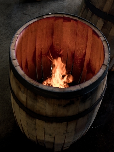 A whisky barrel being charred for storage - Australian Stock Image