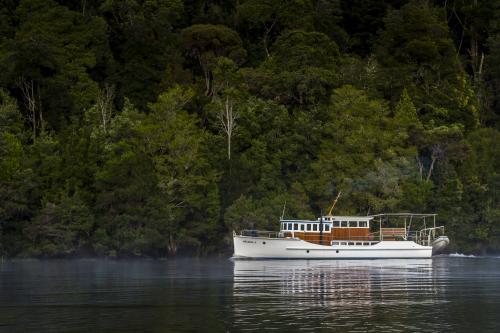 A wooden boat on the Pieman River. - Australian Stock Image