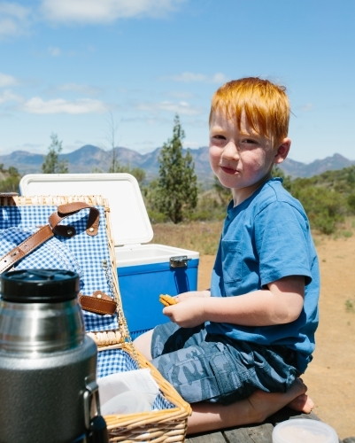 A young boy having a picnic at a rest area in a national park