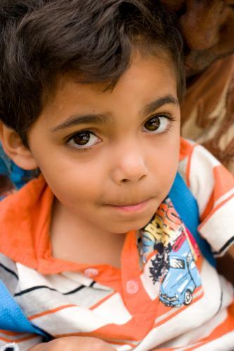 Aboriginal Boy wearing stripe shirt Looking up - Australian Stock Image
