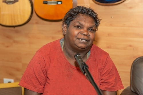 Aboriginal lady singing and playing music