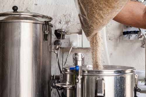 Adding wheat to beer boiler - Australian Stock Image