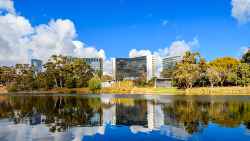 Adelaide Riverbank skyline viewed across Torrens river on a day - Australian Stock Image