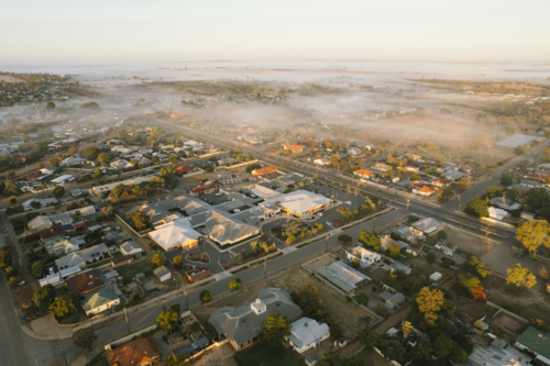 Aerial at sunrise over town of Merredin in the Wheatbelt of Western Australia - Australian Stock Image