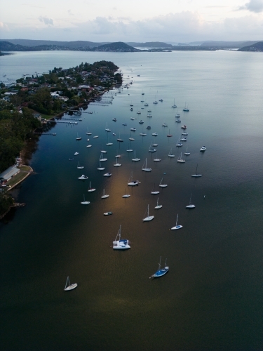 Aerial image looking south from Gosford at boats moored in Brisbane Water at dusk - Australian Stock Image