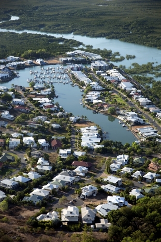 Aerial image of housing with surrounding water and bushland - Australian Stock Image