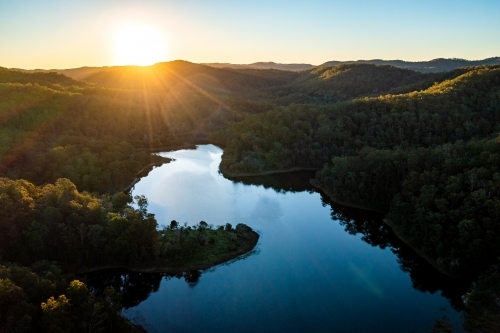 Aerial landscape of a lake surrounded by forest - Australian Stock Image