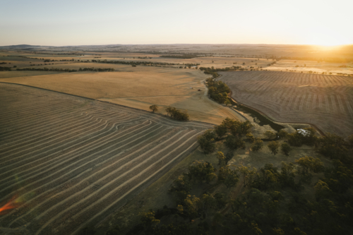 Aerial of harvest landscape on sunset in the Avon Valley of Western Australia - Australian Stock Image