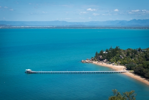 Aerial shot of a coastal landscape with a long pier - Australian Stock Image