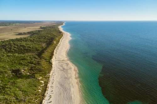 Aerial shot of long sandy beach and the ocean in Australia's South West.