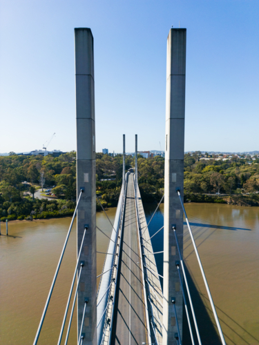 Aerial view between structural pylons of the Eleanor Schonell Bridge looking at the Brisbane River - Australian Stock Image