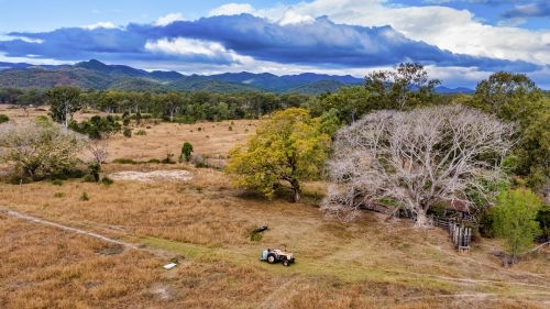 Aerial view of a big field with a tractor driving by - Australian Stock Image