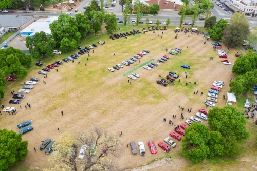 Aerial view of a car rally parked around a cricket oval - Australian Stock Image