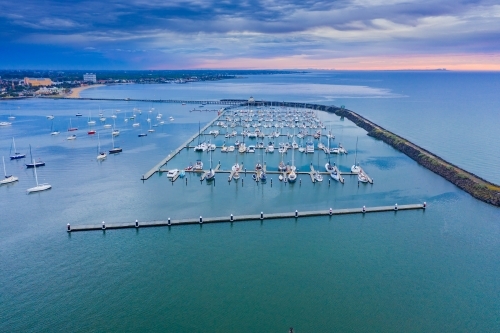 Aerial view of a coastal marina at sunset - Australian Stock Image