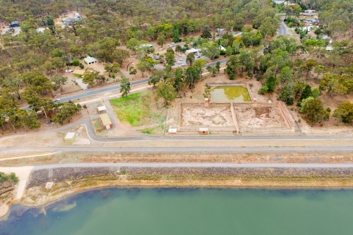 Aerial view of a dam wall and settling ponds - Australian Stock Image