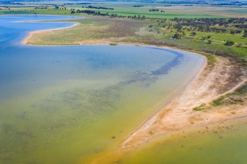 Aerial view of a shallow bay around the shoreline of an inland lake - Australian Stock Image