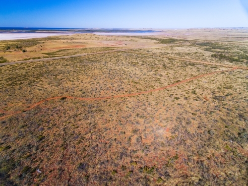 aerial view of arid country towards the sea - Australian Stock Image