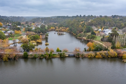 Aerial view of autumn trees along a causeway around Lake Daylesford - Australian Stock Image