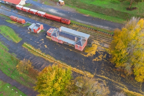 Aerial view of autumn trees surrounding an historic railways - Australian Stock Image