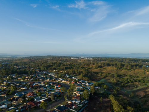 Aerial view of edge of town where bush meets developed land in Singleton - Australian Stock Image