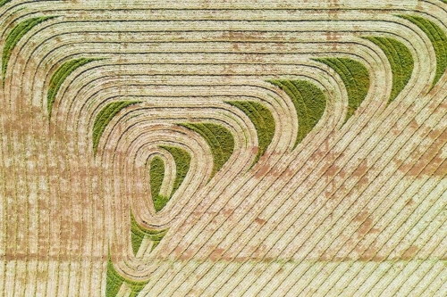 Aerial view of harvesting patterns in an empty paddock - Australian Stock Image