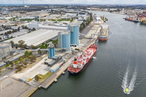 Aerial view of large cargo ships docked along a busy wharf - Australian Stock Image